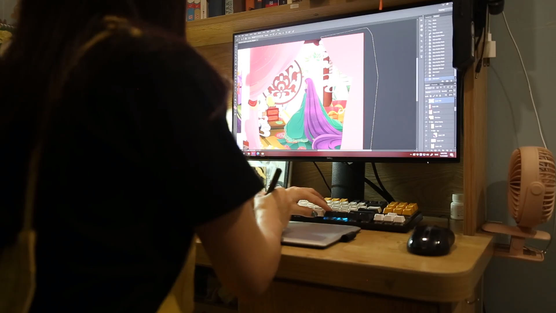 Dang Thanh Huyen next to a computer screen showing a cartoon in a supplied photo