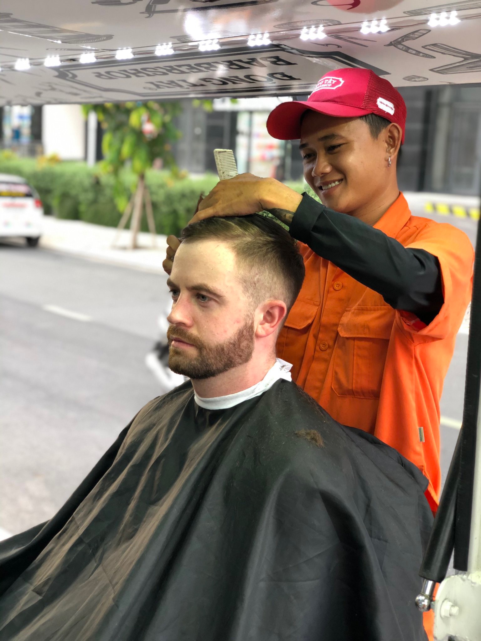 In this supplied photo, an expat enjoys the professional service at Dong Tay mobile barbershop, District 2, Ho Chi Minh City.