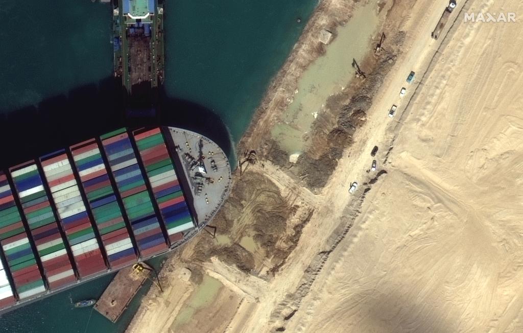 A view of the earth moving equipment excavating sand near the bow of the Ever Given container ship, in Suez Canal in this Maxar Technologies satellite image taken on March 27, 2021. Photo: Satellite image 2021 Maxar Technologies/Handout via Reuters