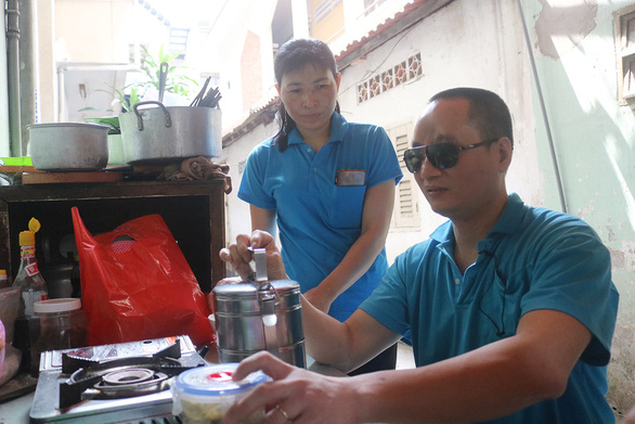 Despite heavy loss from the COVID-19 pandemic, Ho Huy Binh and his wife, who work as a masseur and masseuse in Ho Chi Minh City, Vietnam, stay optimistic about the prospects of their job. Photo: Dieu Qui / Tuoi Tre