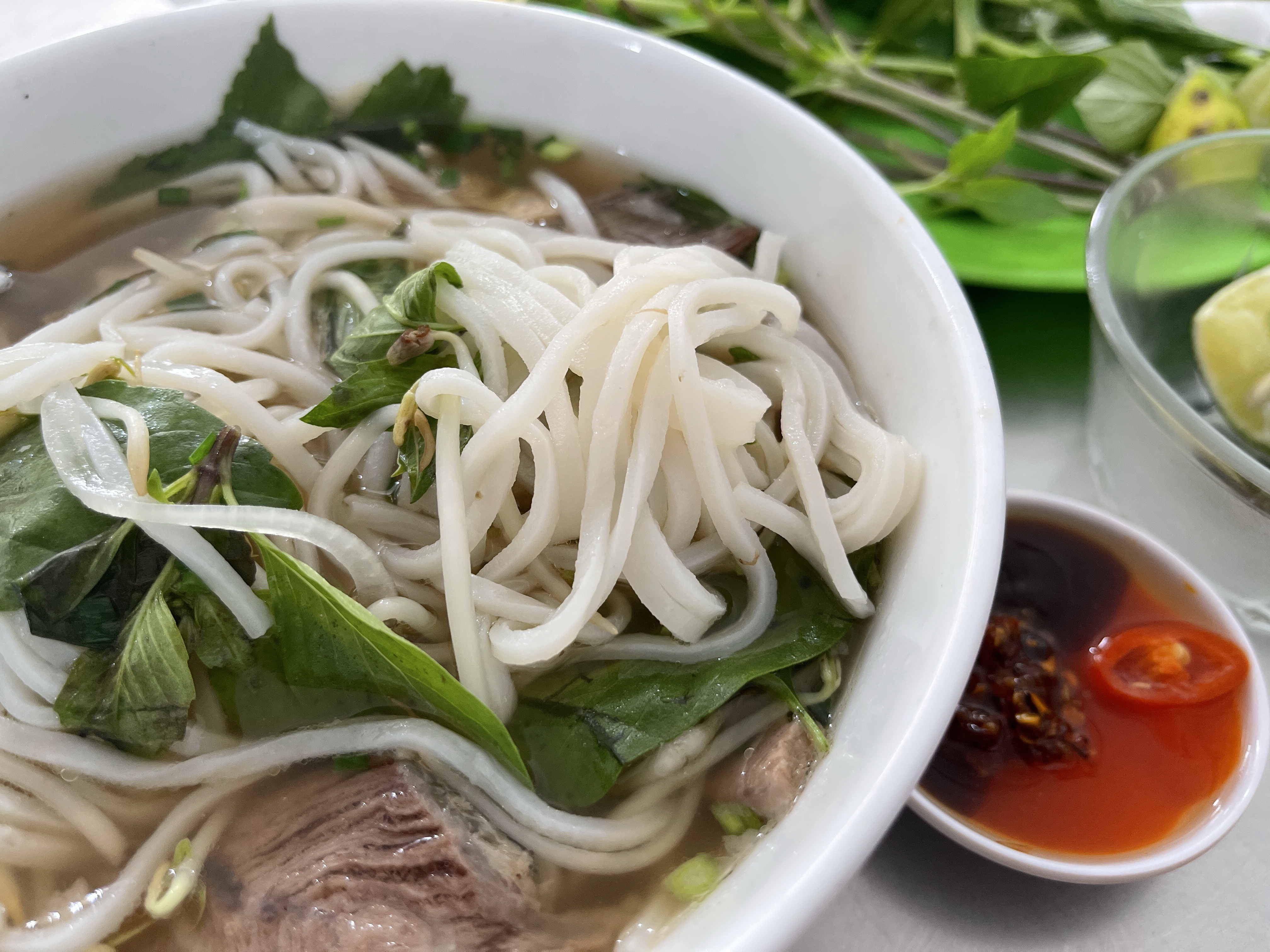 A close-up shot shows the square-shape noodles used in southern-style pho, which are different from the flat noodles used in northern-style pho. Photo: Dong Nguyen / Tuoi Tre News