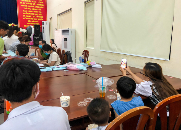 A household is waiting for their turns at a registration booth for chip-based ID card in Ward 9, Go Vap District, Ho Chi Minh City, April 6, 2021. Photo: Minh Hoa / Tuoi Tre