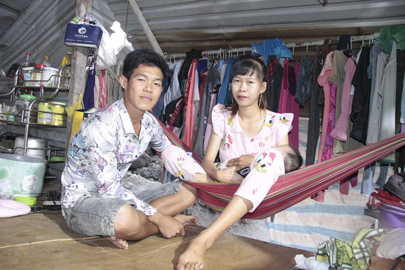 Nguyen Quang Hieu, a young construction worker, poses with his wife and their baby inside the shanty at a building site in Thu Duc City, Ho Chi Minh City. Photo: Cong Trieu / Tuoi Tre