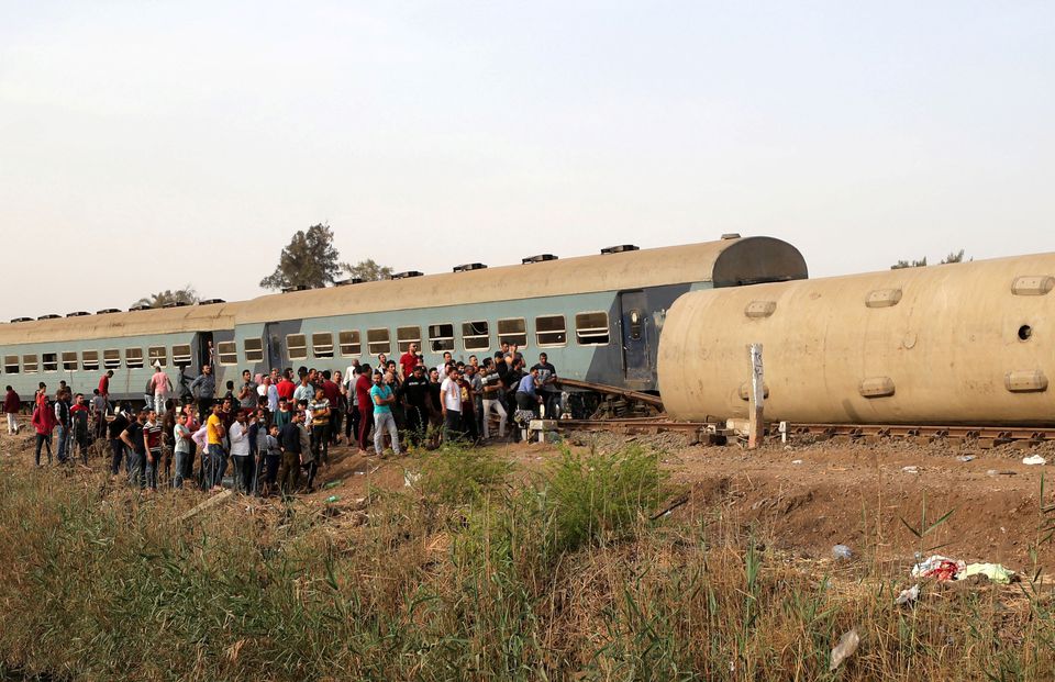 People gather at the site where train carriages derailed in Qalioubia province, north of Cairo, Egypt April 18, 2021. Photo: Reuters