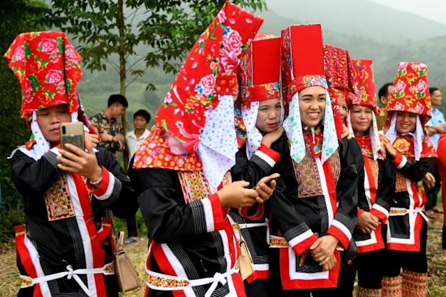 Ethnic Dao women wearing traditional clothing watch a friendly football match as part of the Soong Co festival celebrations in northern Vietnam's Quang Ninh province. Photo: AFP