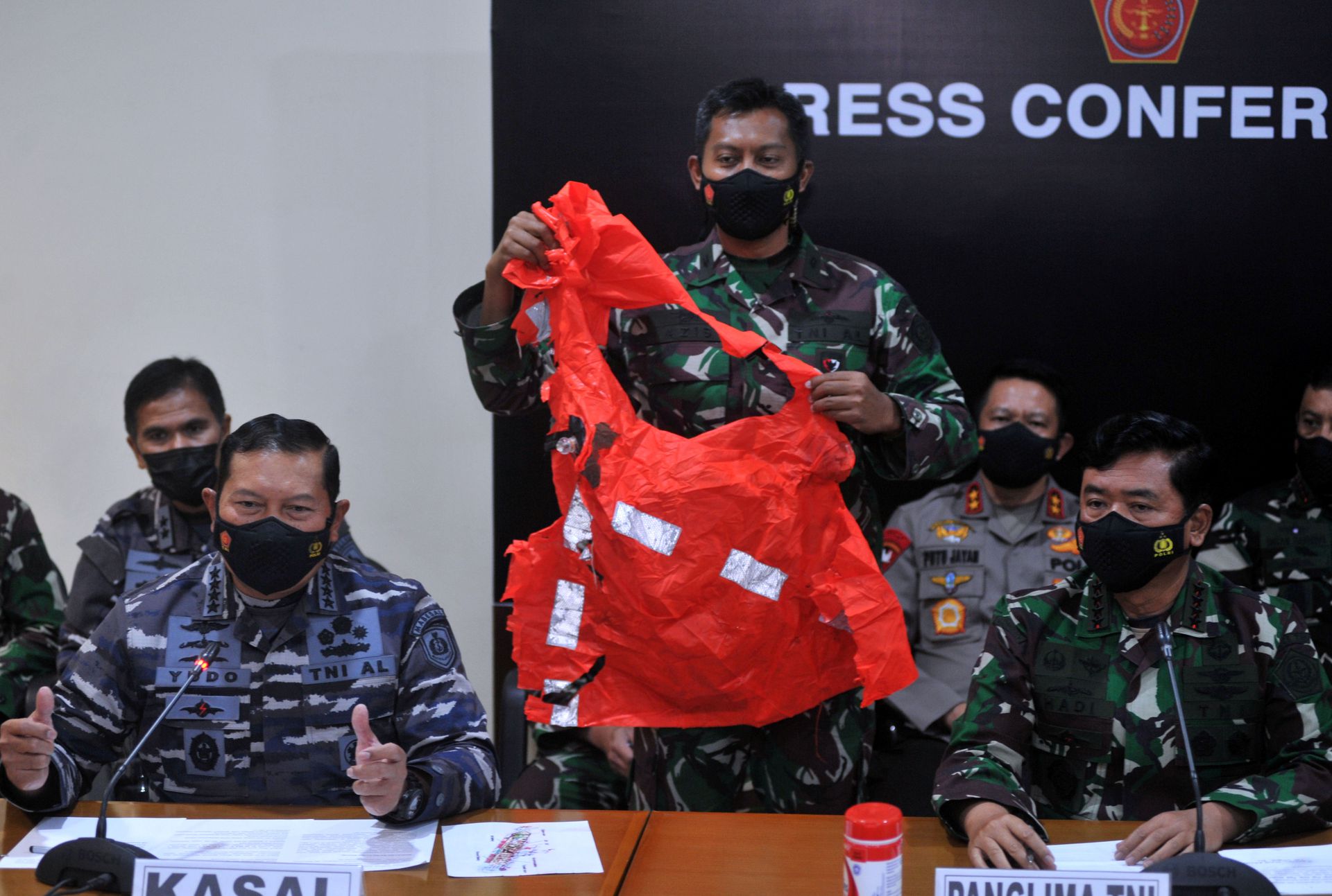A military personnel holds an escape suit believed to be from the sunken Indonesian Navy KRI Nanggala-402 submarine during a media conference at I Gusti Ngurah Rai Airport in Bali, Indonesia April 25, 2021, in this photo taken by Antara Foto/Fikri Yusuf/via Reuters