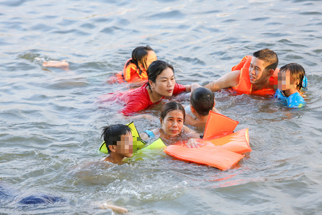 Residents swim in Huong (Perfume) River in Thua Thien - Hue Province, Vietnam despite COVID-19. Photo: Phuoc Tuan / Tien Phong