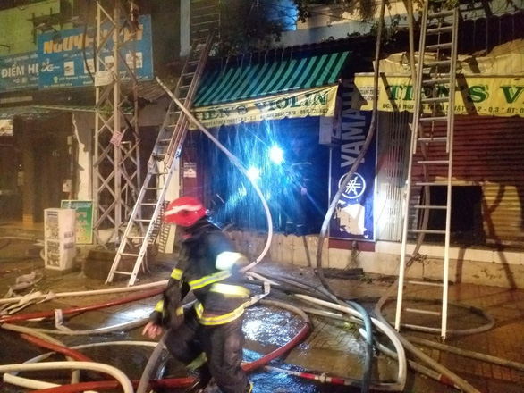 Fire policemen use water hoses to put out a house fire on Nguyen Thien Thuat Street, District 3, Ho Chi Minh City, Vietnam, May 31, 2021. Photo courtesy of Ho Chi Minh City Fire Prevention, Fighting and Rescue Police Department.