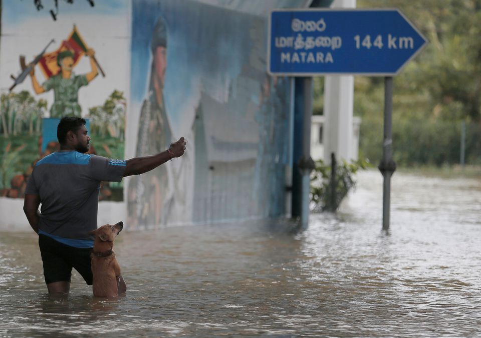 A man takes a selfie picture with his dog in a flooded road during a curfew amid concerns of COVID-19 spread in Kaduwela, a suburb town of Colombo, in Sri Lanka June 6, 2021. Photo: Reuters