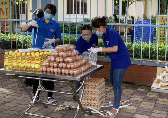 Volunteers restock zero-cost grocery stalls in front of the People’s Committee of Tan Hung Thuan Ward, District 12, Ho Chi Minh City. Photo courtesy of Tan Hung Thuan Ward People’s Committee.