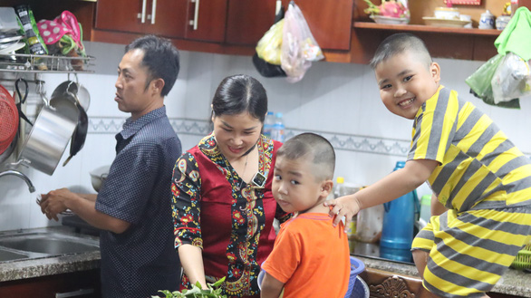 Le Thi Kieu Ngan, a devoted wife, enjoys happy moments with her current husband and their two young sons at their tenanted house in Thu Duc City, Ho Chi Minh City, Vietnam when she is not behind the wheel. Photo: Le Van/ Tuoi Tre