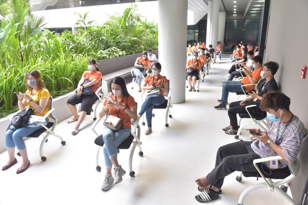 FPT workers are seen waiting for vaccination at the Saigon Hi-tech Park in Ho Chi Minh City on June 19, 2021. Photo: Duyen Phan / Tuoi Tre