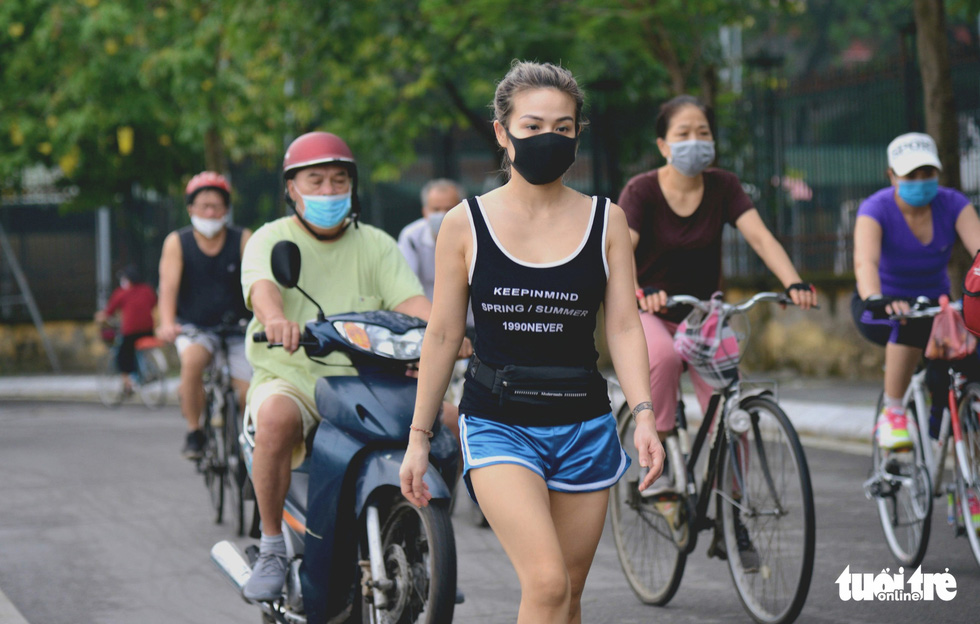 People walk and cycle around the West Lake in Hanoi, June 26, 2021. Photo: Ha Quan / Tuoi Tre