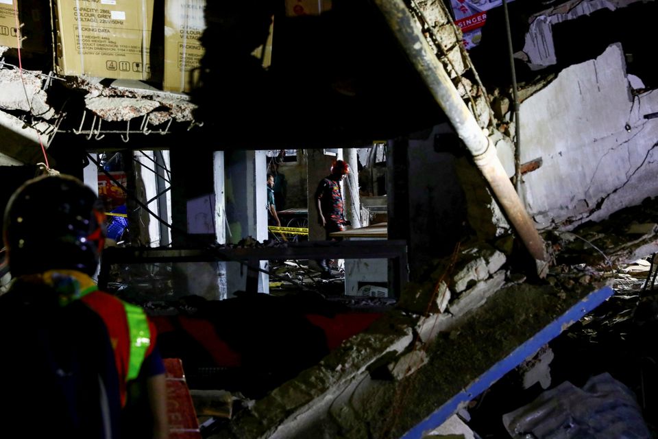 Rescue workers inspect the site after a blast in a shop that killed several people in Dhaka, Bangladesh, June 27, 2021. Photo: Reuters