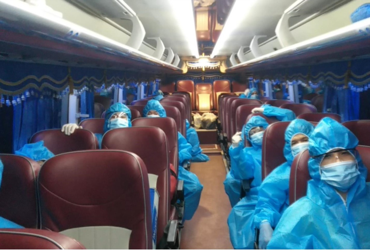 People in protective clothing are picture on a passenger bus in this supplied photo.
