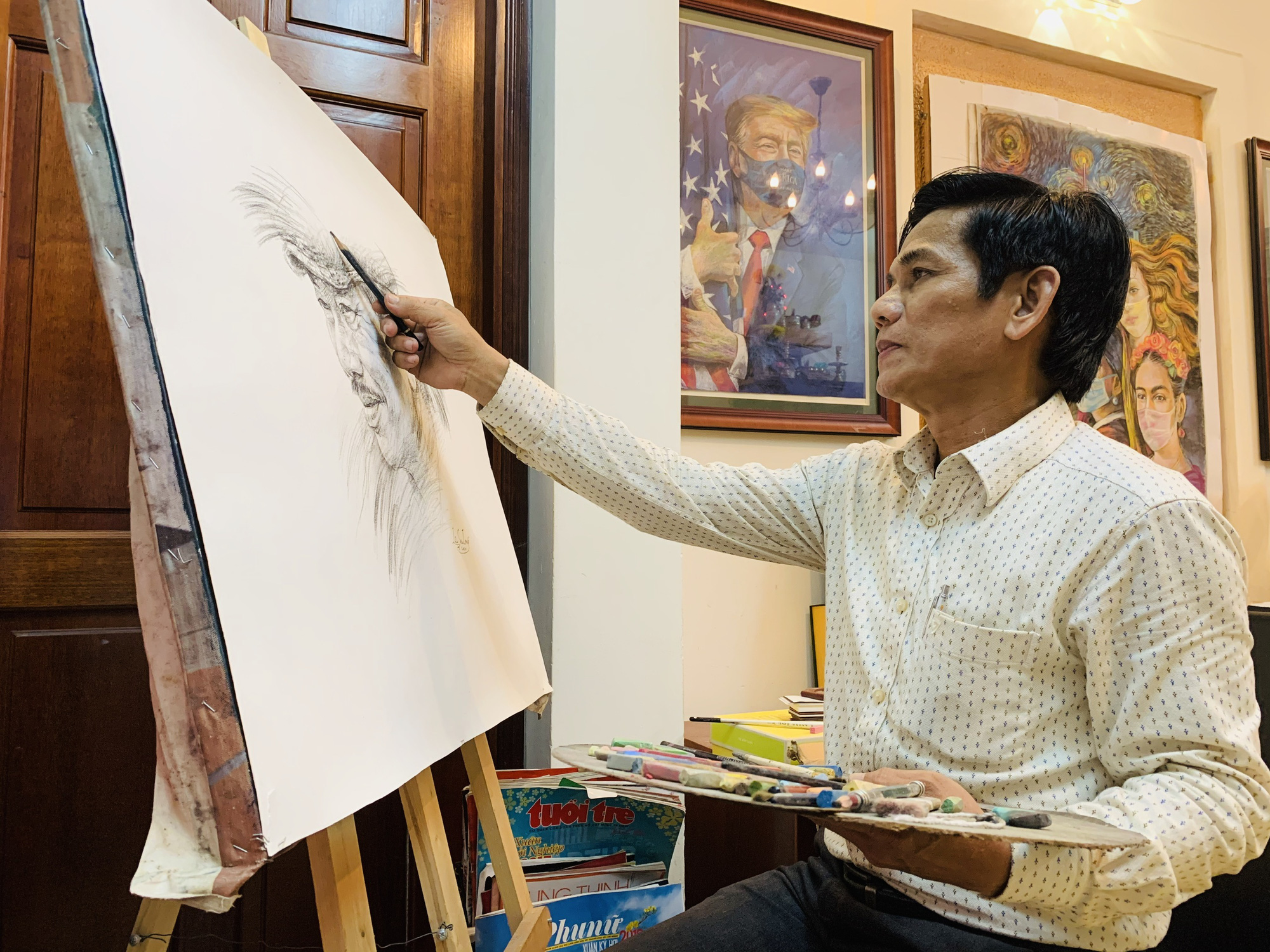 Artist Le Sa Long completes a sketch in his studio in Ho Chi Minh City. Photo: Phuong Nam / Tuoi Tre