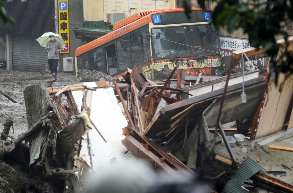 A damaged bus and debris of the houses are seen at a mudslide site following heavy rain at Izusan district in Atami, Japan July 3, 2021. Photo: Kyodo via Reuters