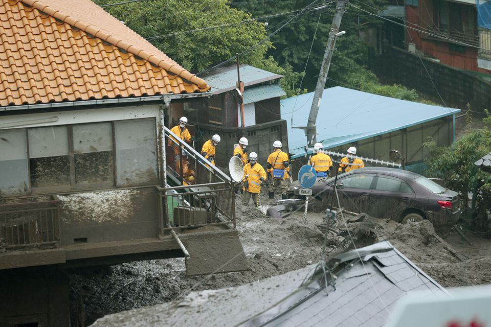 Firefighters conduct search and rescue operation at a mudslide site caused by heavy rain at Izusan district in Atami, west of Tokyo, Japan July 4, 2021. Photo: Kyodo via Reuters