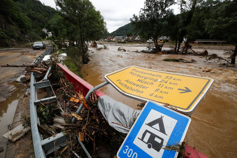 A collapsed sign is seen next to a river at a flood-affected area, following heavy rainfalls, in Schuld, Germany, July 15, 2021. Photo: Reuters