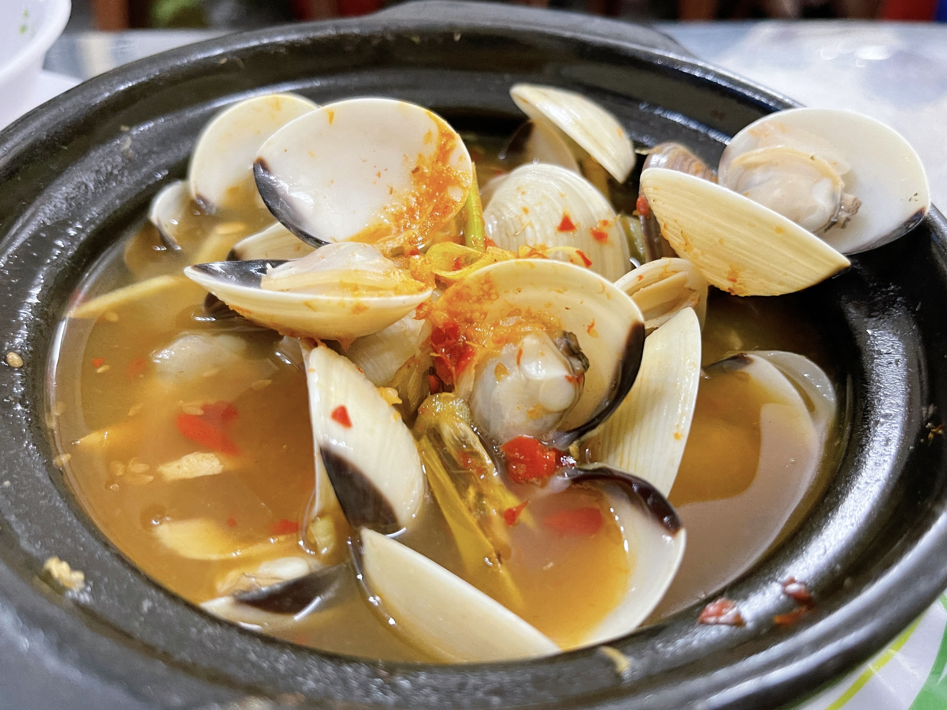 A portion of 'ngheu hap Thai' (clams steamed in Thay style), a famous dish can be found at every snail stall in Saigon. Photo: Dong Nguyen / Tuoi Tre News
