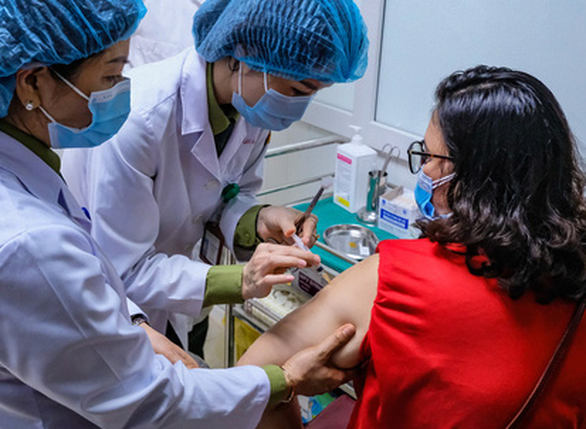 This image shows a woman receiving a Nano Covax vaccine shot in phase 2 human trial conducted by Nanogen in Long An Province, Vietnam. Photo: Nam Tran / Tuoi Tre
