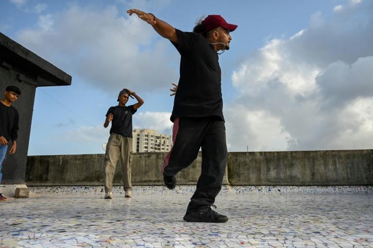 Coach Vikram Godakiya (R) learned breakdancing from YouTube videos -- and for him the school means much more than a steady paycheck. Photo: AFP