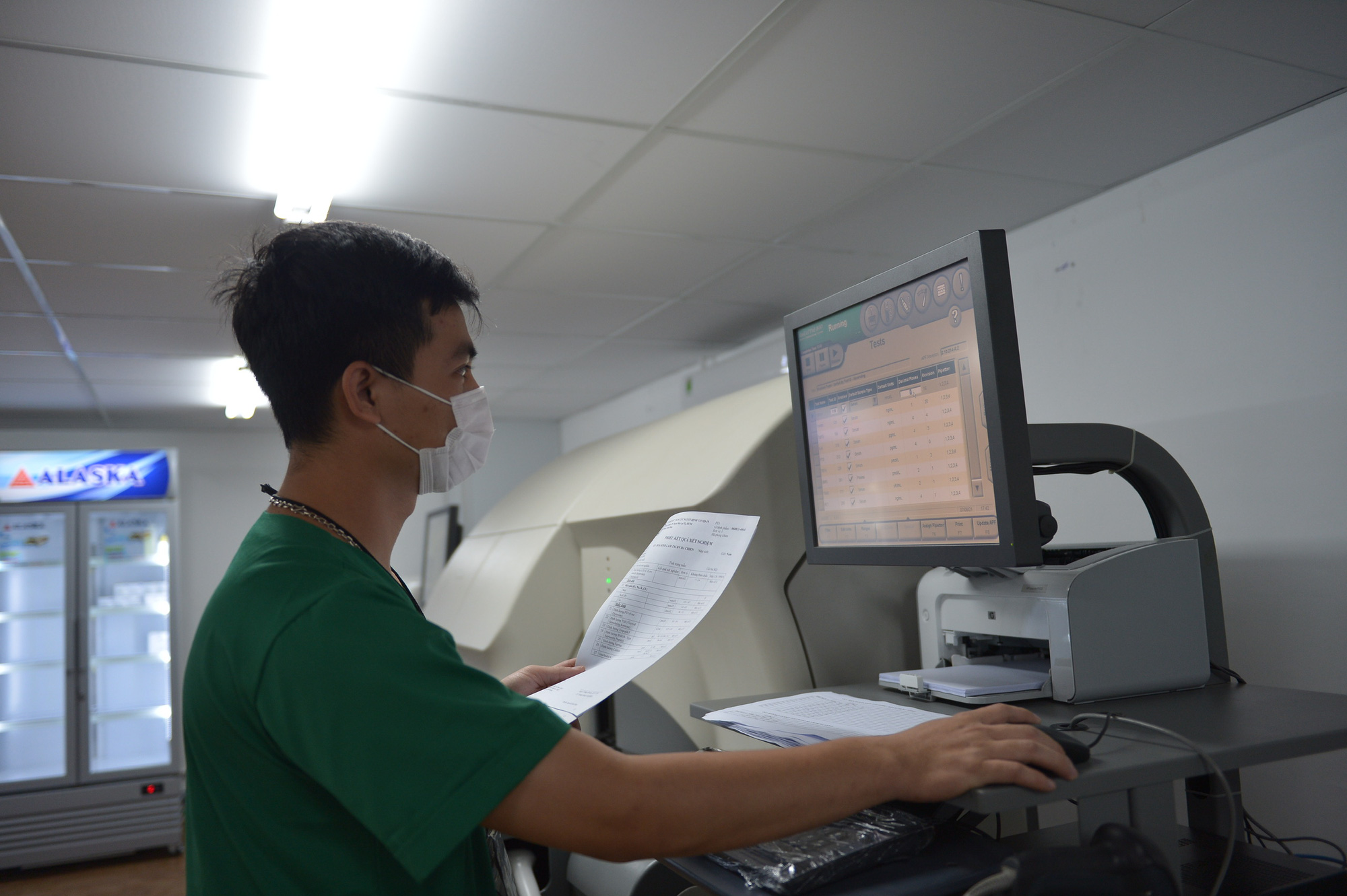 A health worker prepares a COVID-19 testing machine at an intensive care center in Ho Chi Minh City. Photo: Tu Trung / Tuoi Tre