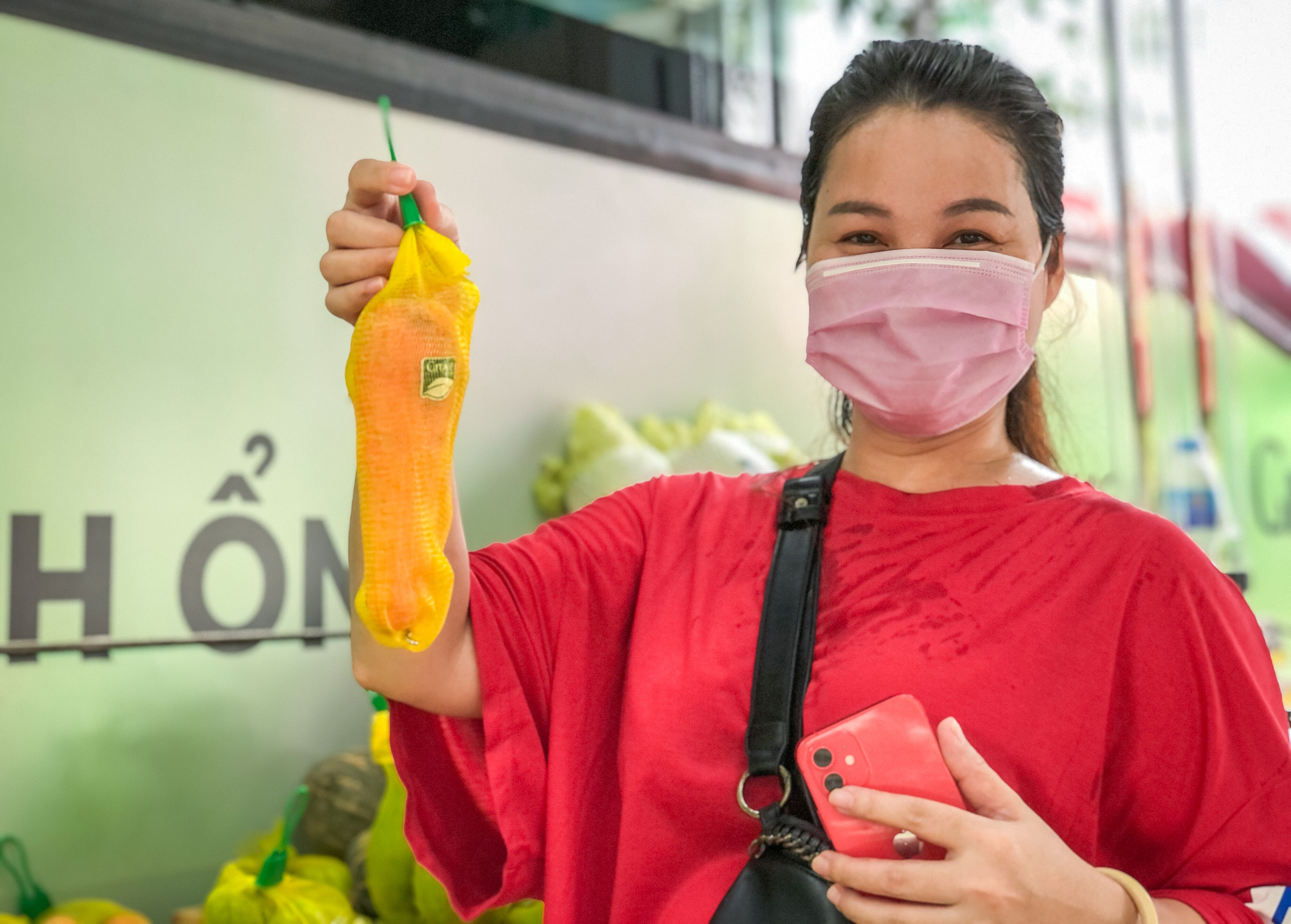 A customer poses with a product she just bought at the mobile mini-supermarket. Photo: Chau Tuan / Tuoi Tre