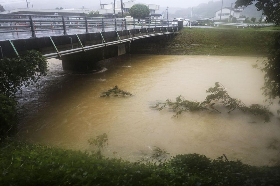 A swollen river caused by a heavy rain is seen in Nagomi Town, Kumamoto prefecture, Japan August 12, 2021, in this photo taken by Kyodo. Mandatory credit Kyodo/via Reuters