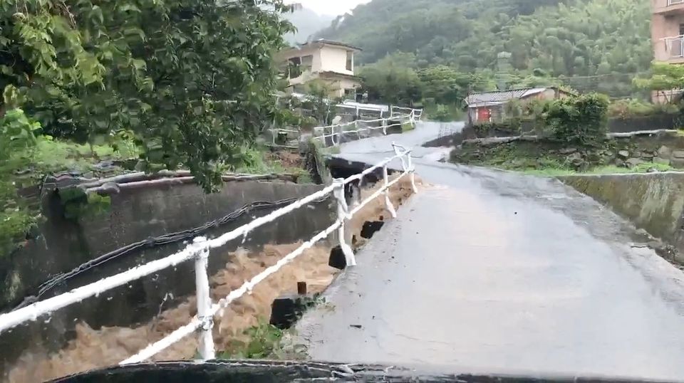 Floodwater seen in a ditch in Kure, Hiroshima Prefecture, Japan after heavy rains, in this August 13, 2021 still frame obtained from social media video. TWITTER @KAPPACHAN1115 /via Reuters