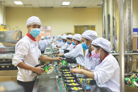 Employees work on a production line at Masan.