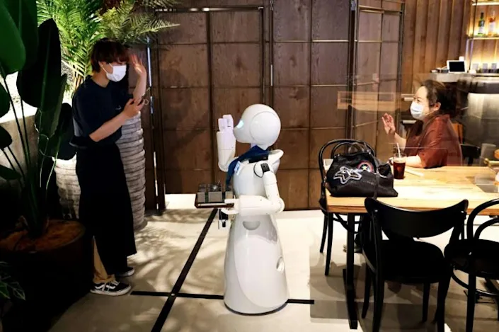 The cafe's robots are largely a medium through which workers can communicate with customers. Photo: AFP