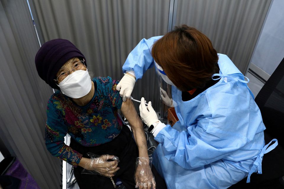 South Korean woman receives her first dose of the Pfizer-BioNTech coronavirus disease (COVID-19) vaccine at a vaccination centre in Seoul, South Korea April 1, 2021. Chung Sung-Jun/Pool via Reuters
