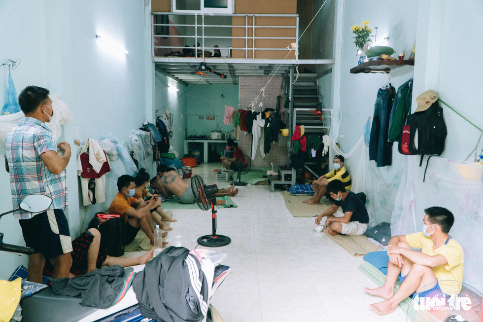A group of construction workers shares a dorm room in Duong Noi Ward of Hanoi’s Ha Dong District during a social distancing period that started in the city on June 2021.