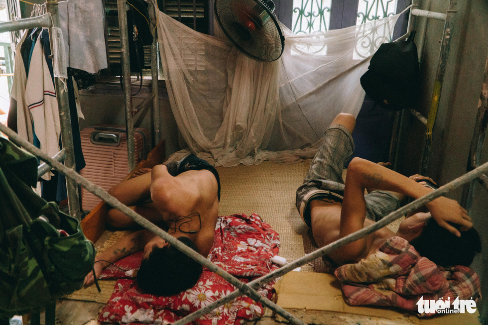 Migrant workers are stuck in a house on Hang Buom Street of Hanoi during a social distancing period that started in the city on June 2021.