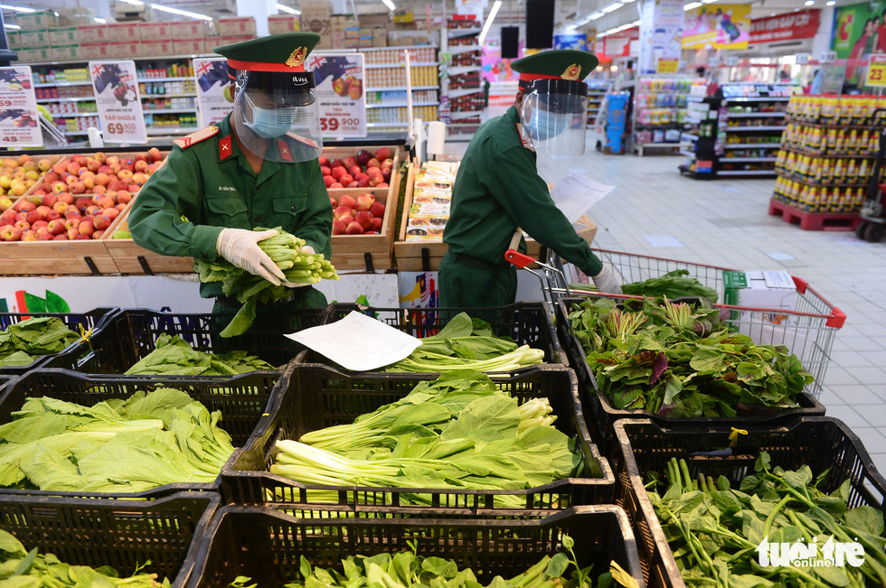Soldiers pick up items based on residents’ orders at Big C Mien Dong Supermarket in District 10, Ho Chi Minh City, Vietnam, August 24, 2021.