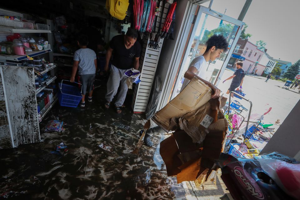 People remove flood-damaged merchandise from the Dollar Depot store that was flooded after the remnants of Tropical Storm Ida brought drenching rain, flash floods and tornadoes to parts of the northeast, in Mamaroneck, New York, U.S., September 2, 2021. Photo: Reuters