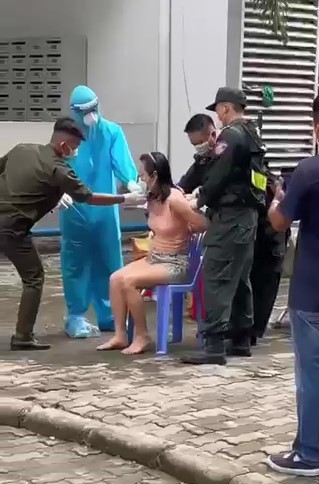 Officers filmed forcing woman to undergo COVID-19 test sampling at apartment building in southern Vietnam