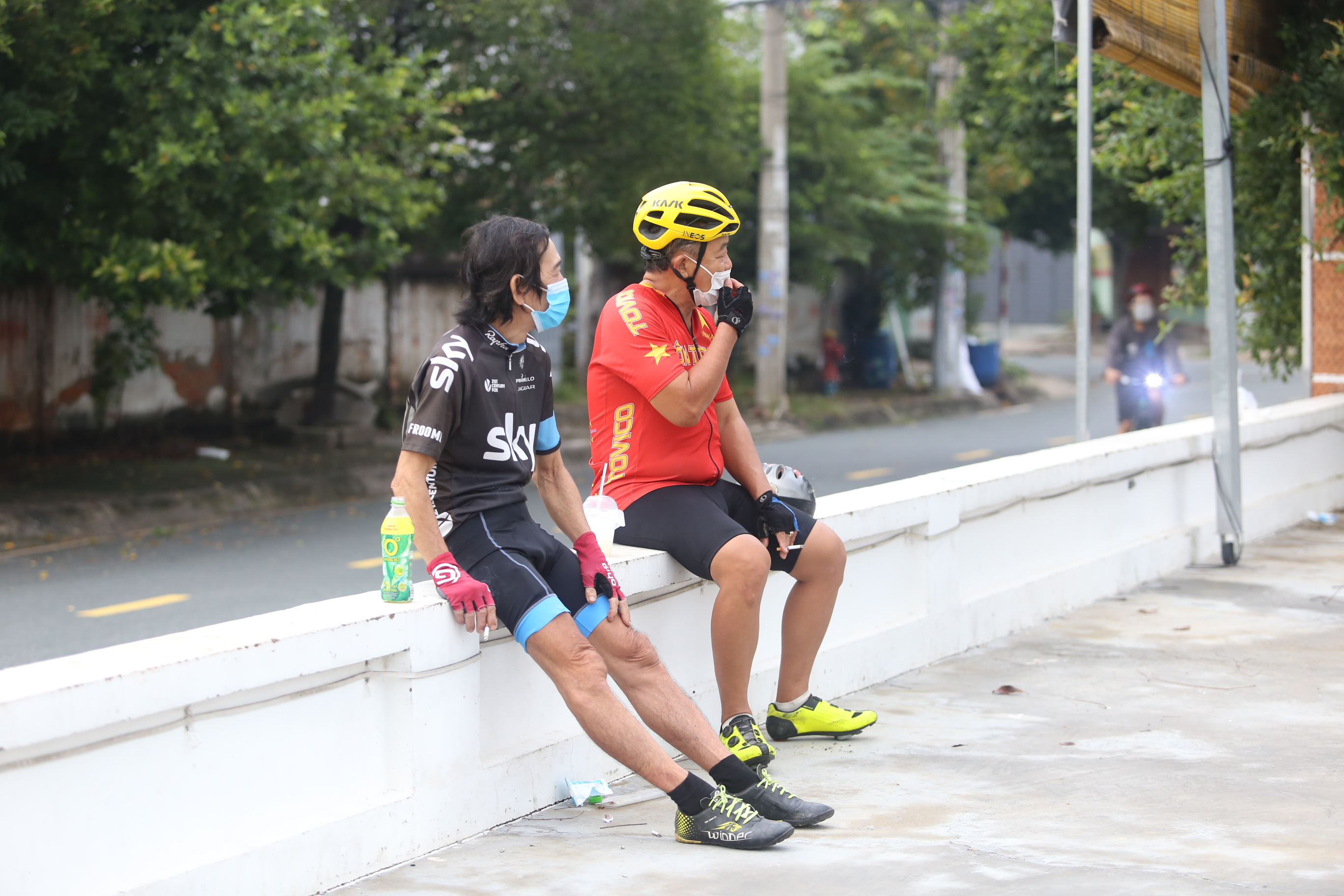 Two men take a break while cycling in Ho Chi Minh City, October 1, 2021. Photo: Le Phan / Tuoi Tre