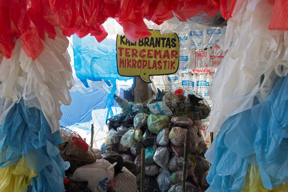 A placard that reads 'Brantas river polluted with microplastic,' is seen among plastic bags displayed at the plastic museum constructed by Indonesia's environmental activist group Ecological Observation and Wetlands Conservation (ECOTON) in Gresik regency near Surabaya, East Java province, Indonesia, September 28, 2021. Photo: Reuters