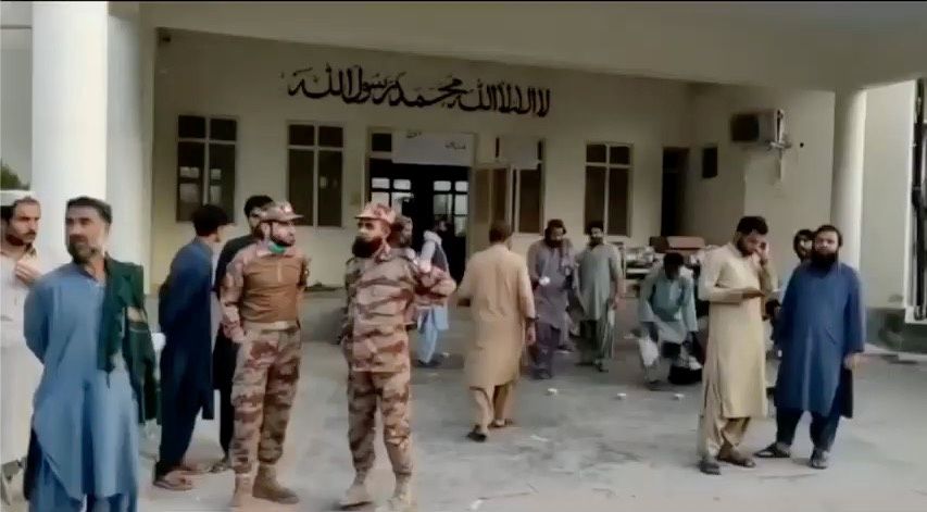 People gather outside a hospital following an earthquake in Harnai, Balochistan, Pakistan, October 7, 2021, in this still image obtained from video. Courtesy of QuettaVoice.com / Social Media via Reuters