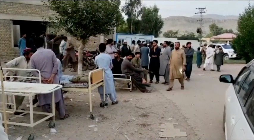 People gather outside a hospital following an earthquake in Harnai, Balochistan, Pakistan, October 7, 2021, in this still image obtained from video. Courtesy of QuettaVoice.com / Social Media via Reuters