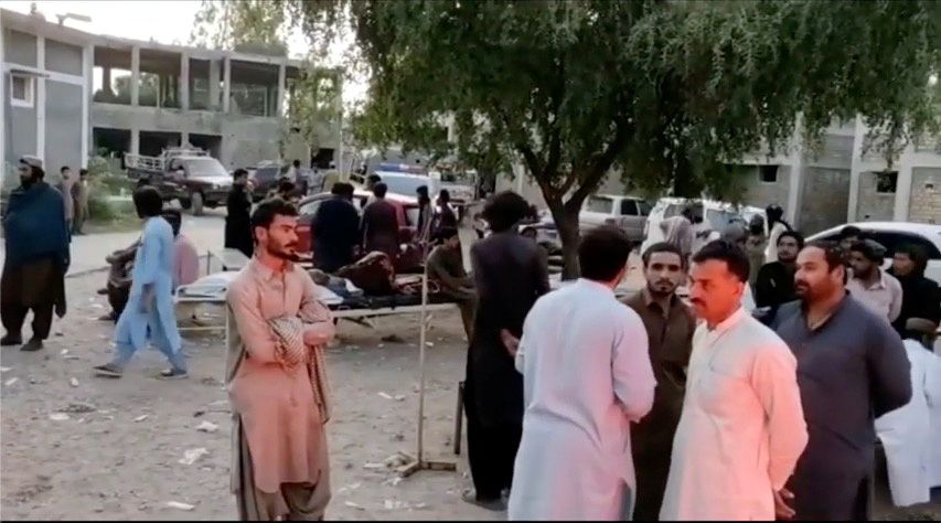 People gather outside a hospital following an earthquake in Harnai, Balochistan, Pakistan, October 7, 2021, in this still image obtained from video. Courtesy of QuettaVoice.com / Social Media via Reuters