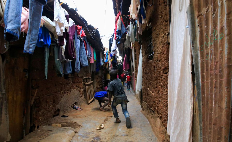 Children play in a courtyard under a hung out laundry amid the coronavirus disease (COVID-19) outbreak, within Kibera slums in Nairobi, Kenya October 6, 2021. Photo: Reuters
