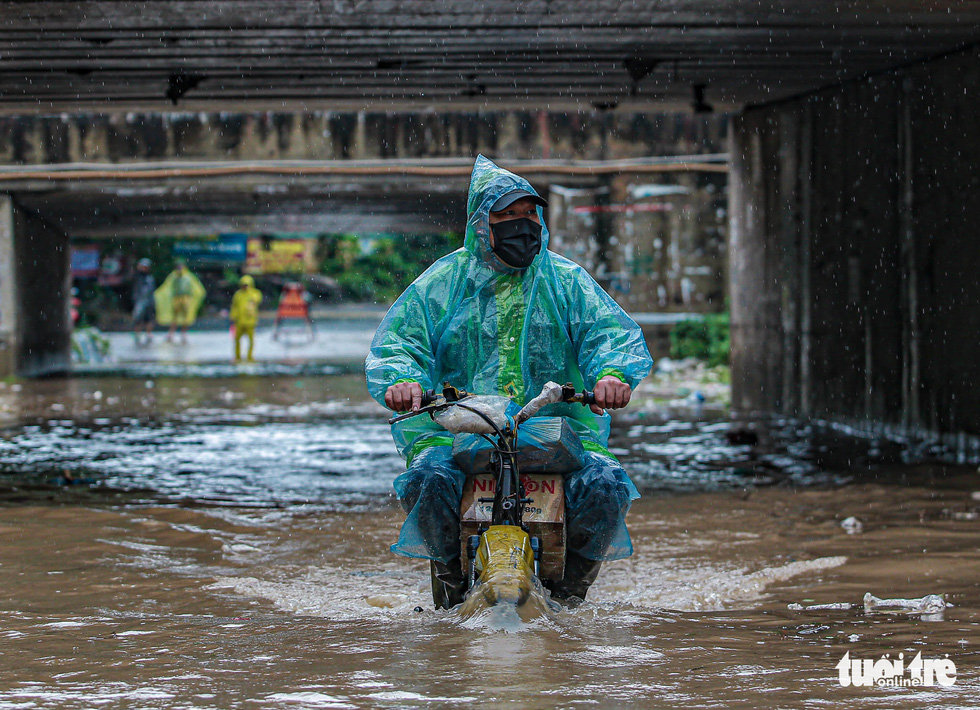 Heavy rain inundates streets in Hanoi