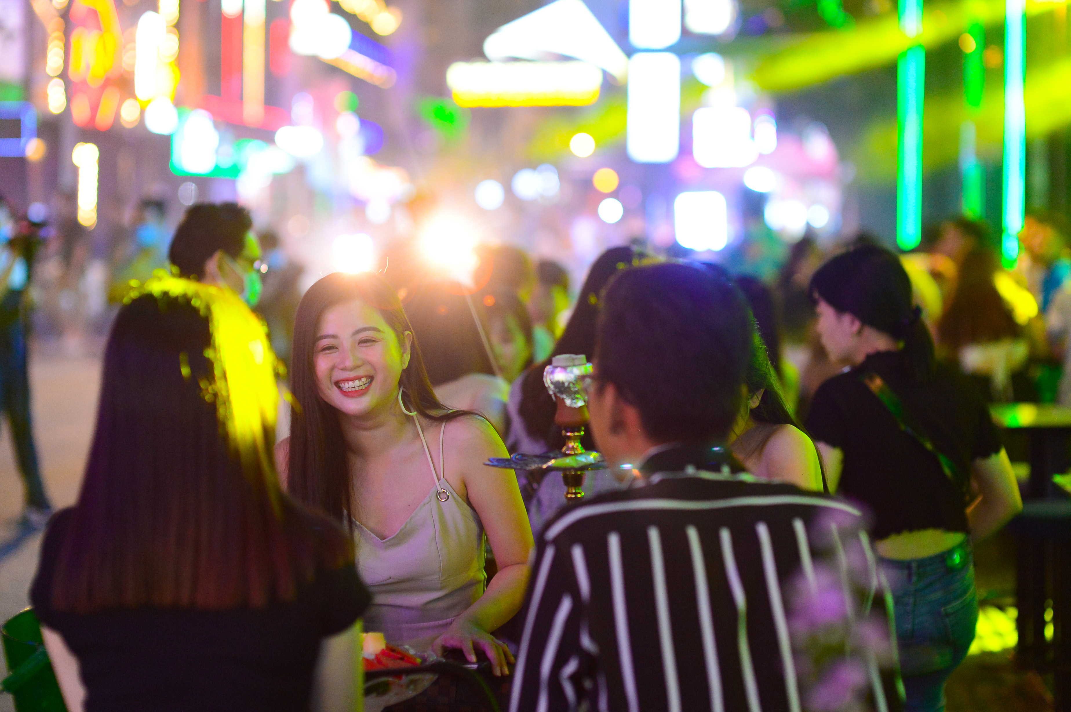 A woman is pictured while hanging out with her friend at a bar on Bui Vien Street in Ho Chi Minh City’s District 1 at around 9:30pm on September 8, 2020. Photo: Quang Dinh / Tuoi Tre