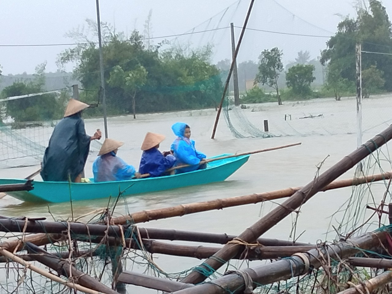 Residents travel on a boat due to serious flooding in Ha Tinh Province, October 17, 2021 in this supplied photo.