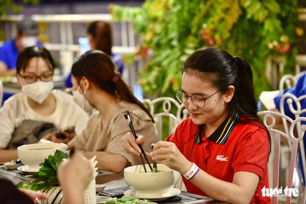Thai Thi Tu Uyen, a nurse from the central province of Nghe An who was sent to work at the COVID-19 field hospitals No.13 in Binh Chanh District, enjoys a bowl of pho at Rex Saigon Hotel in Ho Chi Minh City’s District 1 on October 14, 2021. Photo: Duyen Phan / Tuoi Tre