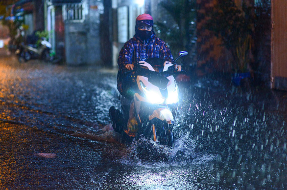 A motorcyclist drives through the flood in Ho Chi Minh City, Vietnam, October 21, 2021. Photo: Quang Dinh / Tuoi Tre