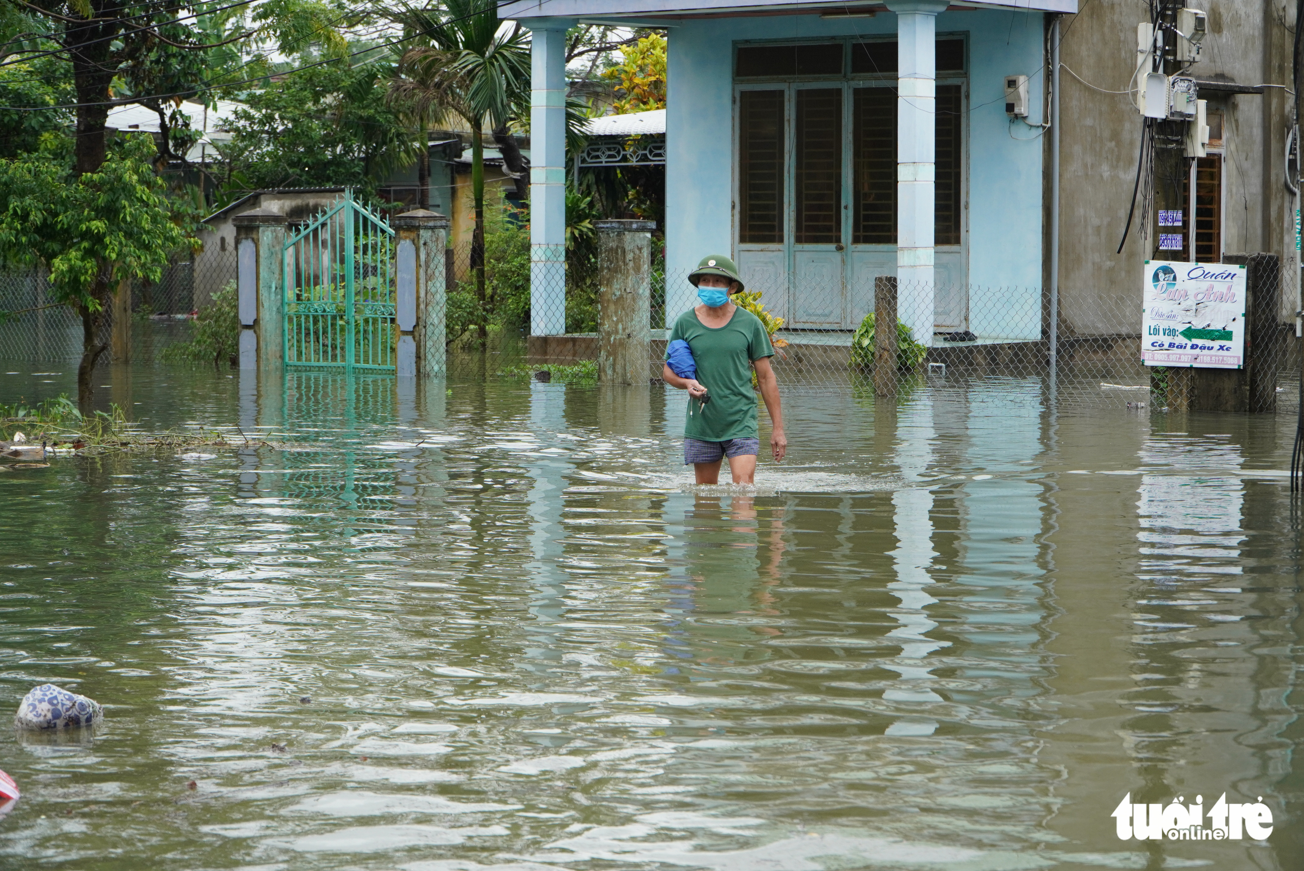 A man walks along a submerged street in Tam Ky City, Quang Nam Province. Photo: Tuoi Tre